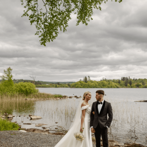 Romantic lakeside wedding with scenic views and lush greenery at a luxurious countryside hotel venue.